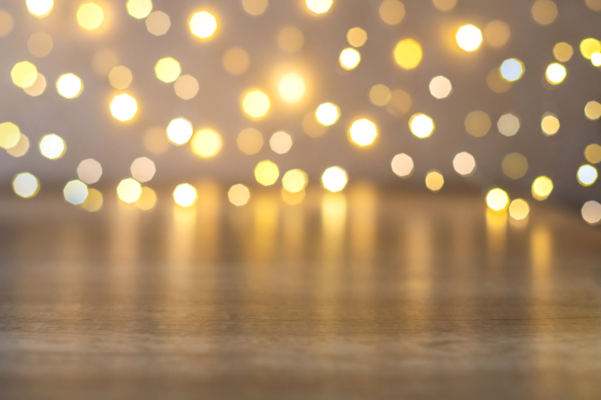 Bokeh of Christmas lights and empty brown wooden table